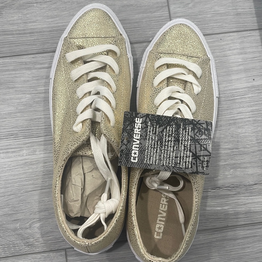 Brand new gold Converse shoes. Size 8 US.